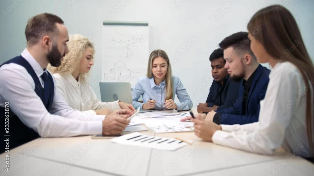Multiethnic team meeting young businesspeople discussing business plan Multiethnic team meeting young businesspeople discussing business plan