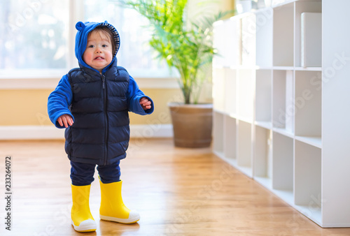 Toddler boy bundled up in winter clothes ready to go outside