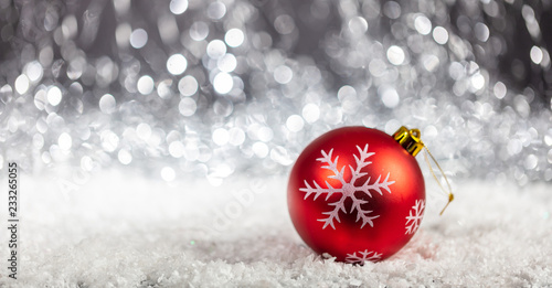 Christmas ball and snow in the night, abstract bokeh lights background