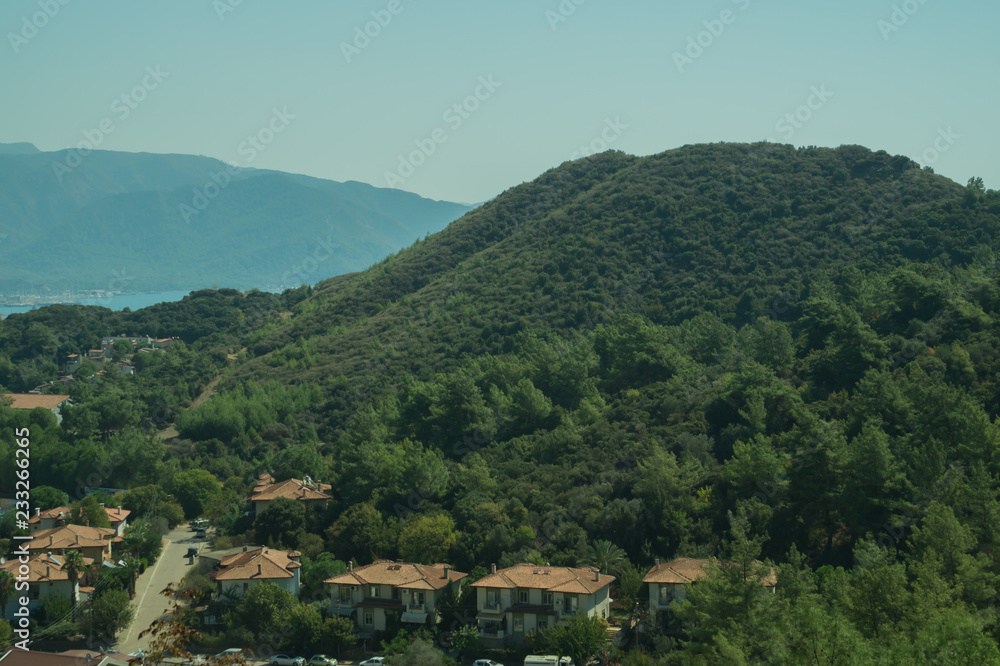 Fototapeta premium Mountain town panoramic view. city between the hills