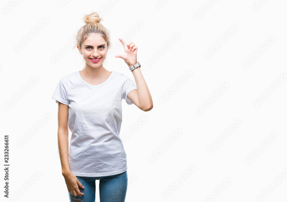 Young beautiful blonde woman wearing white t-shirt over isolated background smiling and confident gesturing with hand doing size sign with fingers while looking and the camera. Measure concept. Young beautiful blonde woman wearing white t-shirt over isolated background smiling and confident gesturing with hand doing size sign with fingers while looking and the camera. Measure concept.