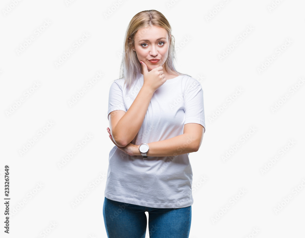 Fototapeta premium Young blonde woman over isolated background looking confident at the camera with smile with crossed arms and hand raised on chin. Thinking positive.