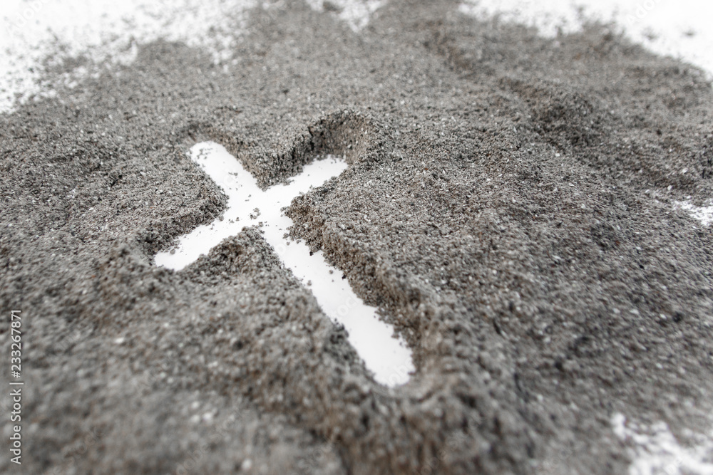 Fototapeta premium Christian cross or crucifix drawing in ash, dust or sand as symbol of religion, sacrifice, redemtion, Jesus Christ, ash wednesday, Ash Wednesday concept