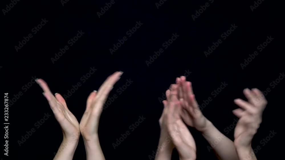 Hands isolated on black background giving applause. Hands clapping on black, front view