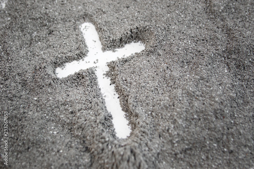 Christian cross or crucifix drawing in ash, dust or sand as symbol of religion, sacrifice, redemtion, Jesus Christ, ash wednesday, Ash Wednesday concept