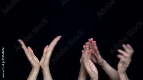 Hands isolated on black background giving applause. Hands clapping on black, front view