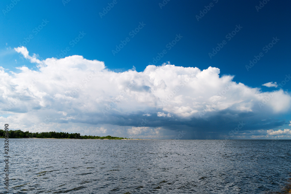Estuary of the Vistula River to the Baltic Sea with the Cumulus mediocris cloud in the sky. Pomerania, Poland.