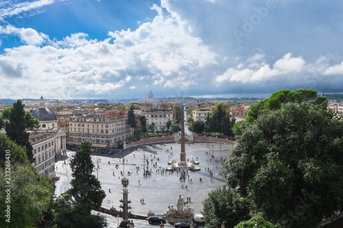 The panoramic vie of Piazza del Popolo shot from above - Terazza del Pincio. The Cupola of San Pietro Cathedral is visible in the distance. photo