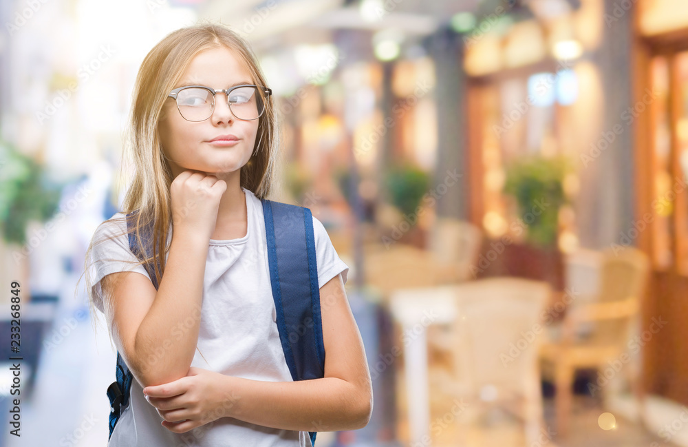 Young beautiful smart student girl wearing backpack over isolated background with hand on chin thinking about question, pensive expression. Smiling with thoughtful face. Doubt concept. Young beautiful smart student girl wearing backpack over isolated background with hand on chin thinking about question, pensive expression. Smiling with thoughtful face. Doubt concept.