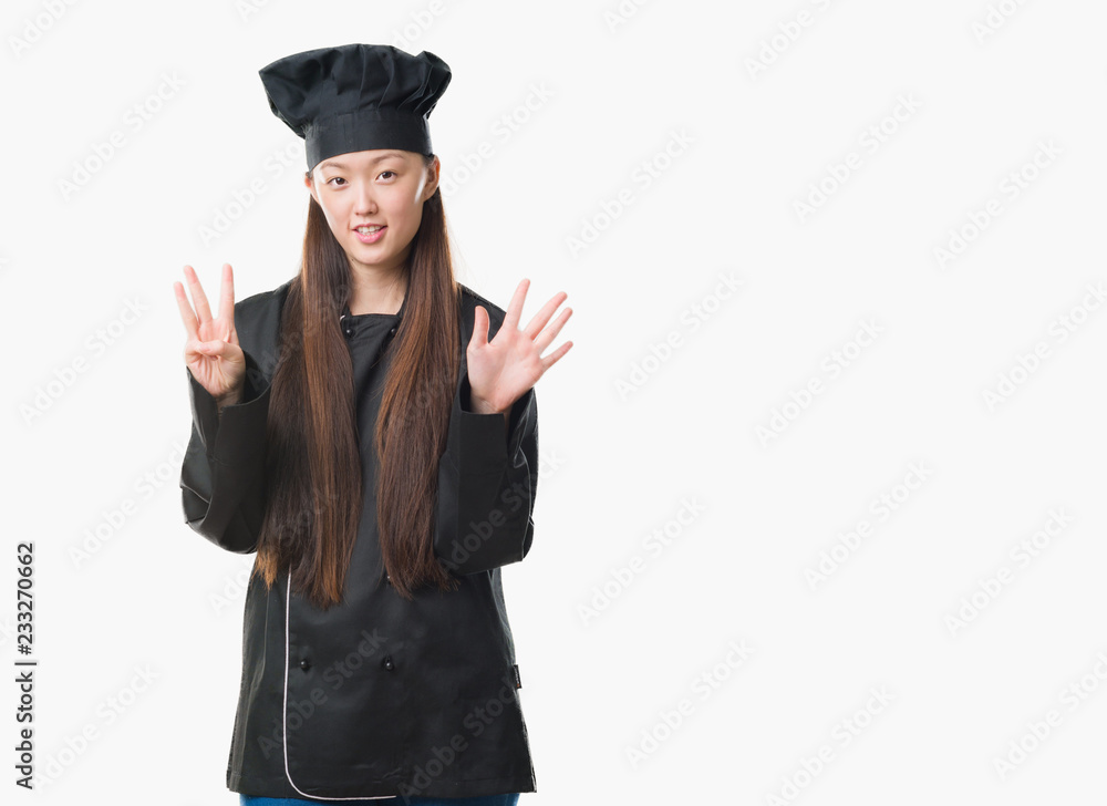 Young Chinese woman over isolated background wearing chef uniform showing and pointing up with fingers number eight while smiling confident and happy. Young Chinese woman over isolated background wearing chef uniform showing and pointing up with fingers number eight while smiling confident and happy.
