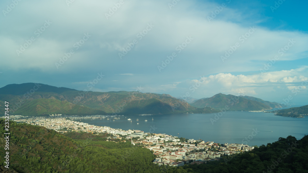 Mountain town panoramic view. city between the hills with the sea Mountain town panoramic view. city between the hills with the sea