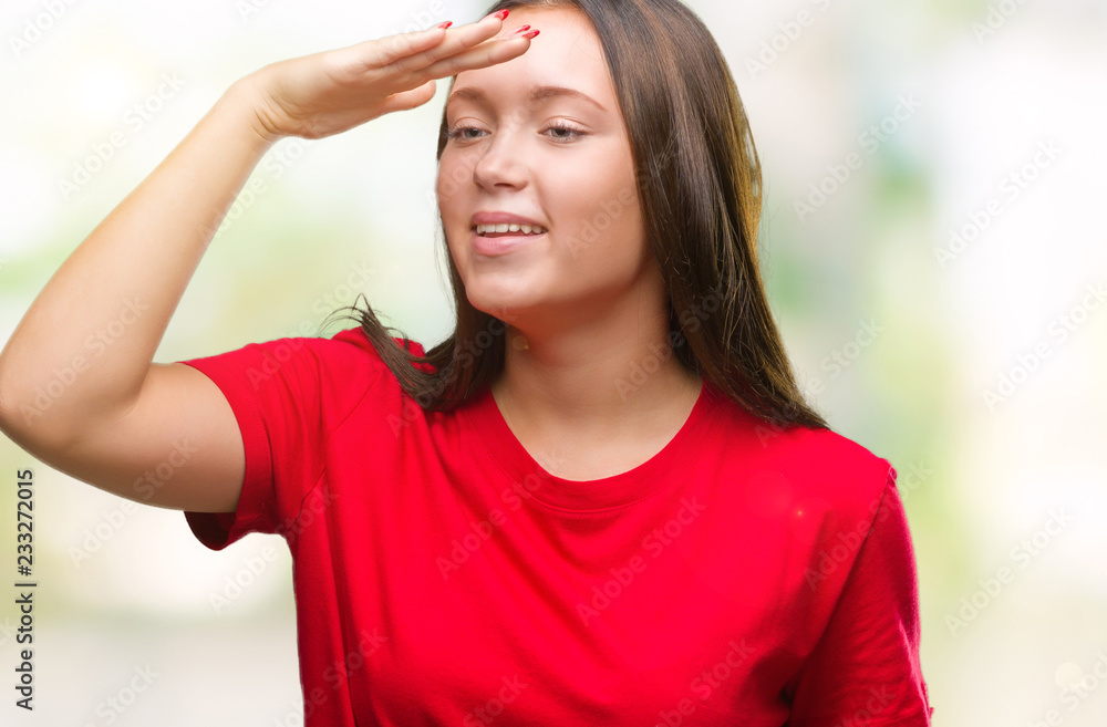 Young beautiful caucasian woman over isolated background very happy and smiling looking far away with hand over head. Searching concept. Young beautiful caucasian woman over isolated background very happy and smiling looking far away with hand over head. Searching concept.