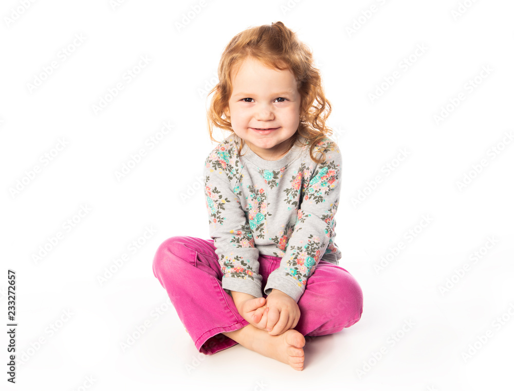 A cute Little Girl with redhead in studio white background A cute Little Girl with redhead in studio white background