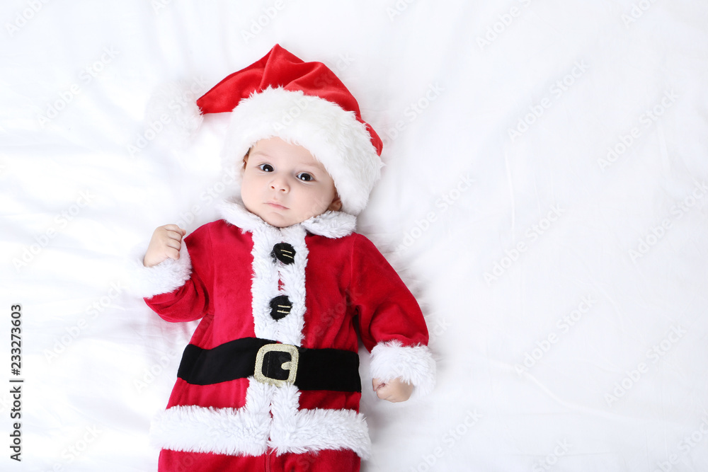 Little boy in christmas costume lying on bed Little boy in christmas costume lying on bed