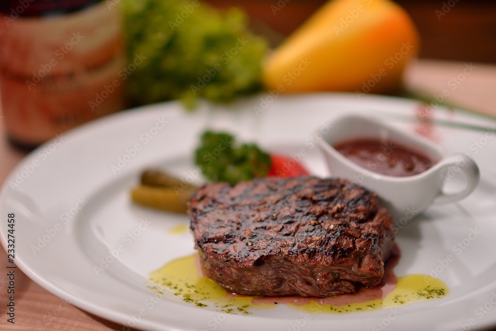steak with vegetables and sauce on a white plate steak with vegetables and sauce on a white plate