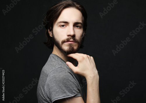 lifestyle and people concept:young man has excited expression, dresssed casually