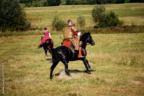Medieval equestrian robber chases the horseback woman