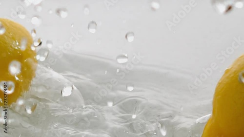 lemon falling in water with splashers photo