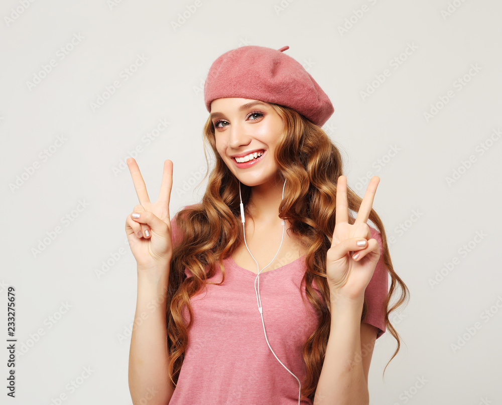 emotion and people concept: Beautiful girl with long wavy hair listening to music emotion and people concept: Beautiful girl with long wavy hair listening to music