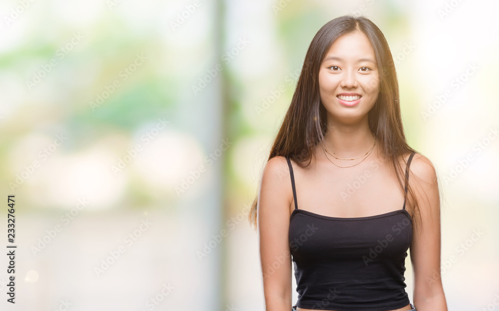 Young asian woman over isolated background with a happy and cool smile on face. Lucky person.