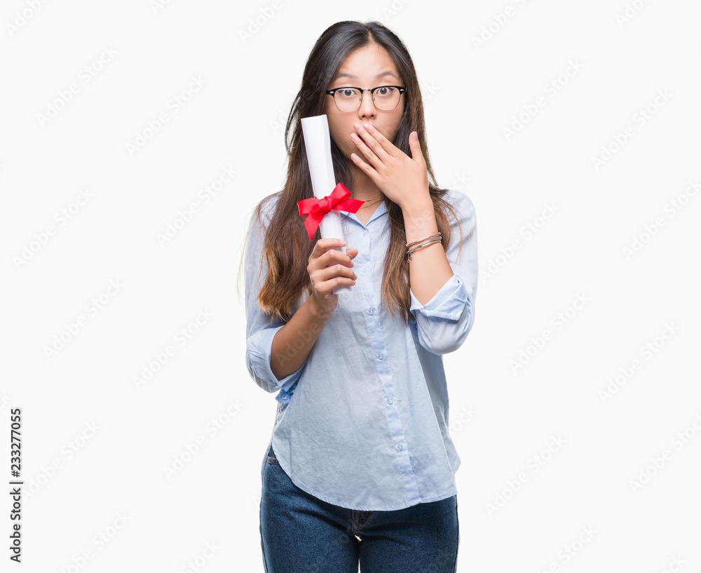 Young asian woman holding degree over isolated background cover mouth with hand shocked with shame for mistake, expression of fear, scared in silence, secret concept Young asian woman holding degree over isolated background cover mouth with hand shocked with shame for mistake, expression of fear, scared in silence, secret concept