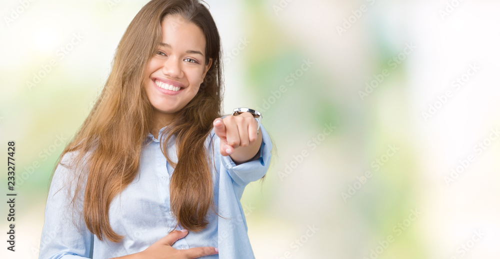 Young beautiful brunette business woman over isolated background Laughing of you, pointing to the camera with finger hand over chest, shame expression Young beautiful brunette business woman over isolated background Laughing of you, pointing to the camera with finger hand over chest, shame expression
