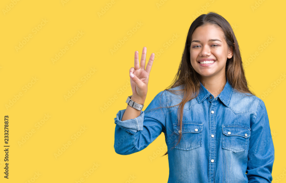 Young beautiful brunette woman wearing blue denim shirt over isolated background showing and pointing up with fingers number three while smiling confident and happy. Young beautiful brunette woman wearing blue denim shirt over isolated background showing and pointing up with fingers number three while smiling confident and happy.