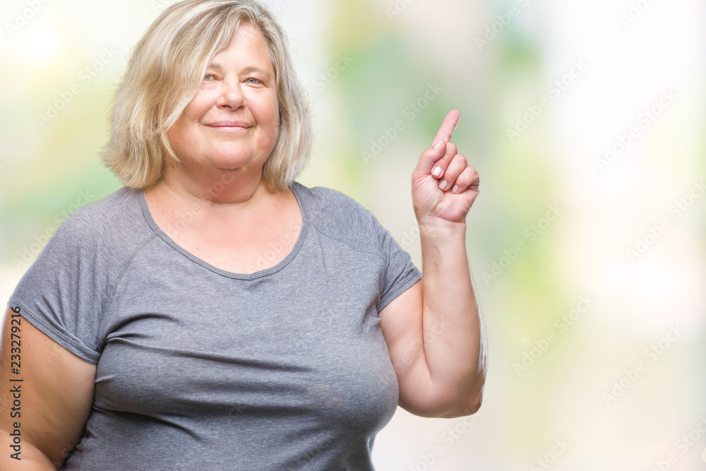 Senior plus size caucasian woman over isolated background with a big smile on face, pointing with hand and finger to the side looking at the camera. Senior plus size caucasian woman over isolated background with a big smile on face, pointing with hand and finger to the side looking at the camera.