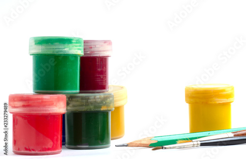 materials for creativity - jars of colorful gouache brushes and pencil