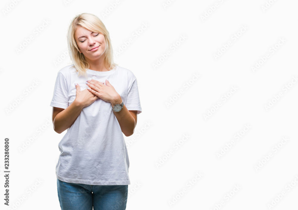 Young beautiful blonde woman wearing white t-shirt over isolated background smiling with hands on chest with closed eyes and grateful gesture on face. Health concept. Young beautiful blonde woman wearing white t-shirt over isolated background smiling with hands on chest with closed eyes and grateful gesture on face. Health concept.