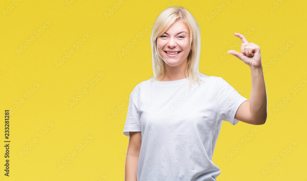 Young beautiful blonde woman wearing white t-shirt over isolated background smiling and confident gesturing with hand doing size sign with fingers while looking and the camera. Measure concept. Young beautiful blonde woman wearing white t-shirt over isolated background smiling and confident gesturing with hand doing size sign with fingers while looking and the camera. Measure concept.