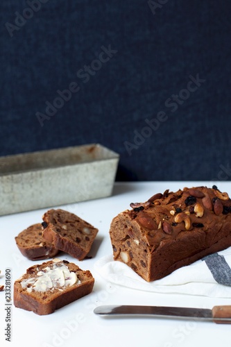 Sliced fruit bread, with a slice spread with butter photo