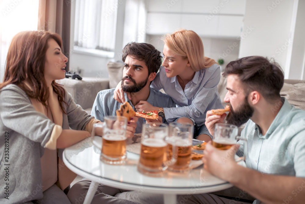 Group of friends enjoying pizza and beer Group of friends enjoying pizza and beer