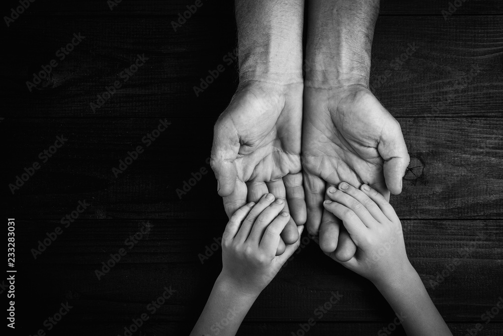Adult Male Hands Holding Kid Hands, Family Help Care Concept