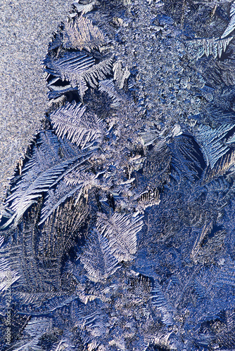 Frosted window. Ice patterns on glass surface.