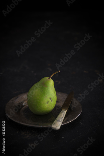 Bürgermeisterbirne (Mayor's pear) on a plate with a knife photo