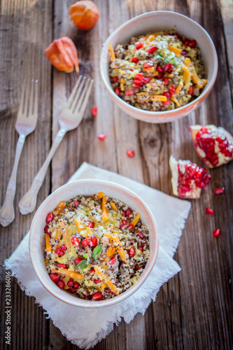 Quinoa bowl with a lemon and mustard dressing and pomegranate seeds photo