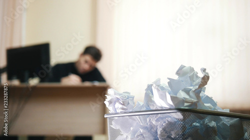 Εκτύπωση καμβά A man in office writing something, focus on the trashcan.