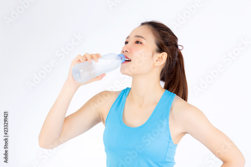 Beautiful portrait asian young woman in sport clothing drink bottle of water for healthy isolated on white background, girl with fit thirsty after exercise and fitness, health concept.