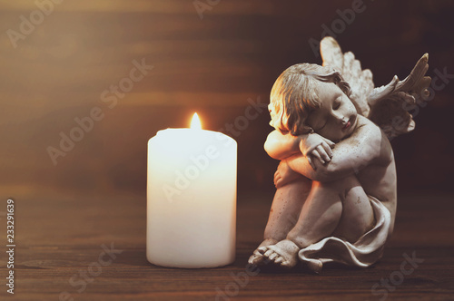 Angel and white burning candle