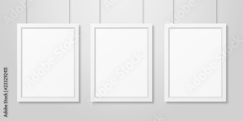 Three Vector Realistic Modern Interior White Blank Vertical A4 Wooden Poster Picture Frame Set Hanging on the Ropes on White Wall Mock-up. Empty Poster Frames Design Template for Mockup, Presentation