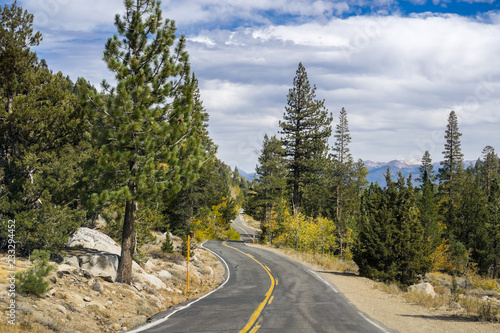 Driving through the Sierra mountains on a sunny autumn day, California © Sundry Photography