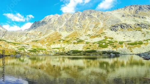 Hiking in High Tatras Mountains, Slovakia. Lake over Skok waterfall (Slovak: Pleso nad Skokom) (1801m). Mounts Satan (2421m), Predna Basta (2374m), Mala Basta (2288m) on the background. Time Lapse photo