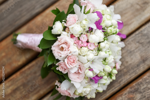 Bridal bouquet in rustic place, for use in wedding websites or blogs. © RHJ