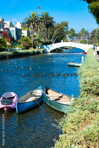 Canoes in a canal and a bridge over one of the canals in Venice, California