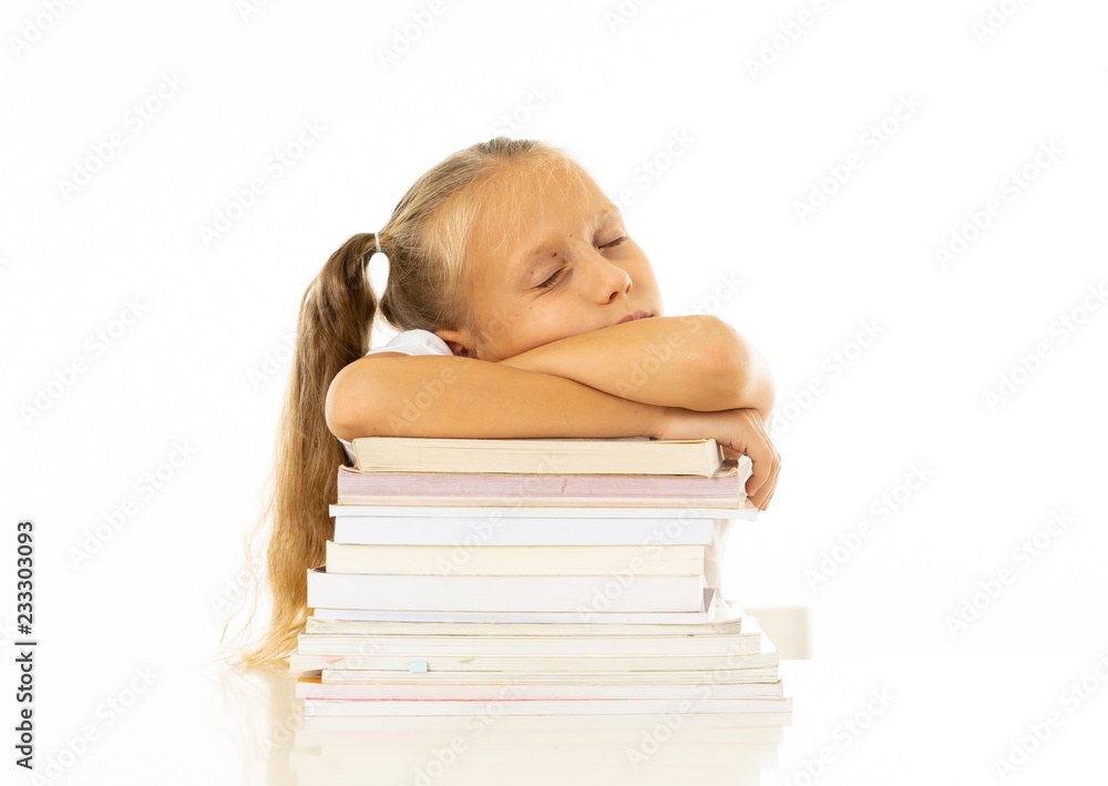 Exhausted schoolgirl falling asleep on her books after studying too much Exhausted schoolgirl falling asleep on her books after studying too much
