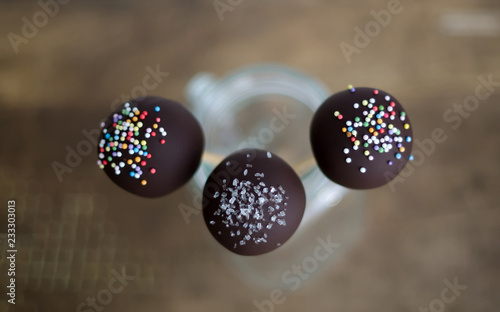 Three delicious chocolate cake pops in a jar.