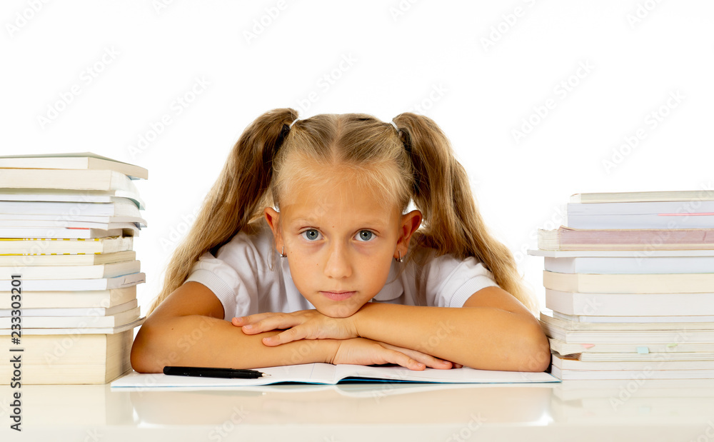 Sad unhappy cute little girl overwhelm with homework and studies Sad unhappy cute little girl overwhelm with homework and studies