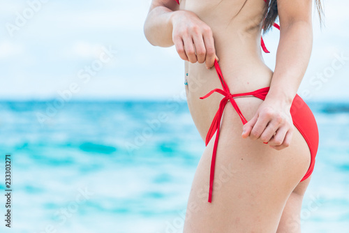Asian women in the red bikini at the beach of Thailand