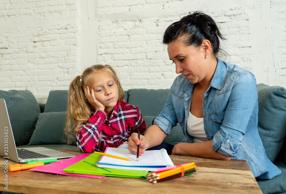 Mum helping her child studying while the girl complains Mum helping her child studying while the girl complains